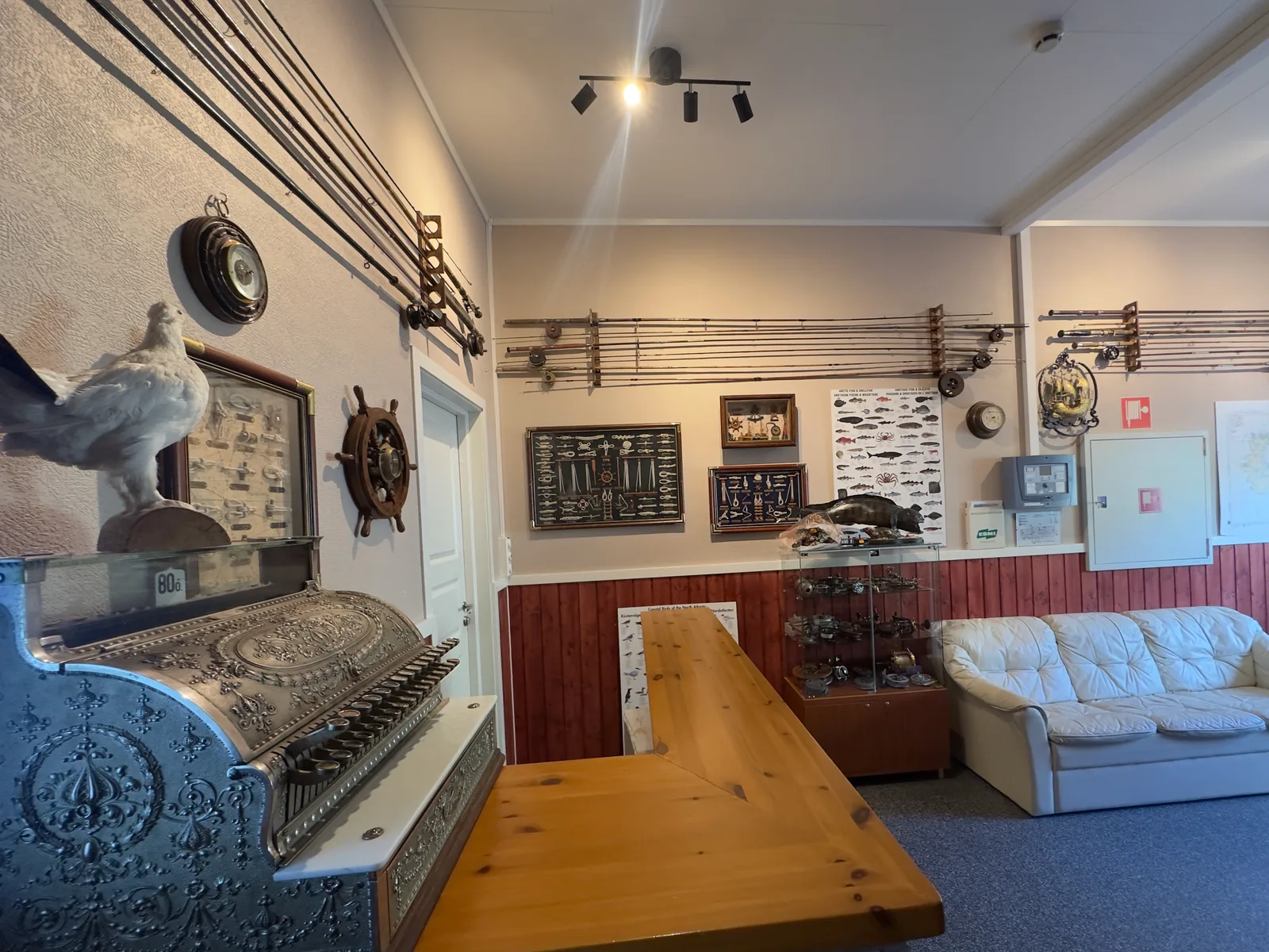 A shared lounge at Myrfjord with fishing displays and seating.