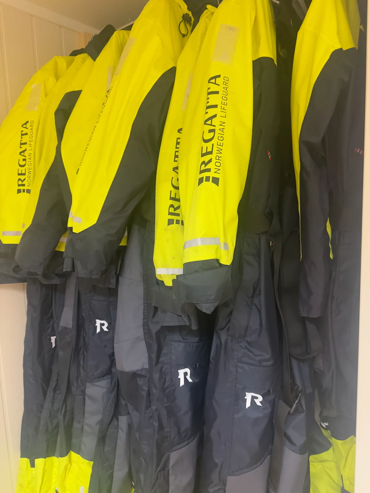 Yellow and black fishing suits hanging at Myrfjord Sjøhus
